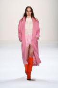 pink wool coat and orange boots